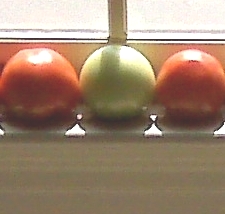 2 red tomatoes with green one in between